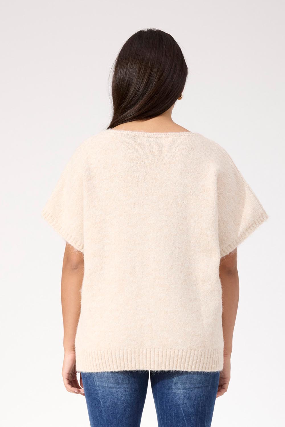A model wearing the Valenza Knit Vest in colour Natural, from the back