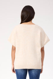 A model wearing the Valenza Knit Vest in colour Natural, from the back