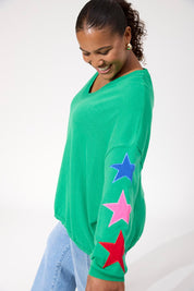 A model wearing the Vermont Star V Neck Jumper in colour Green (Green), from the front, cropped image