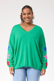 A model wearing the Vermont Star V Neck Jumper in colour Green (Green), from the front, cropped image