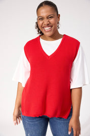 A model wearing the Alaska Knit Vest in colour Red (Red), from the front, cropped image