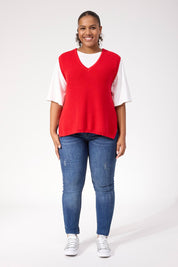 A model wearing the Alaska Knit Vest in colour Red (Red), from the front, showing the whole outfit