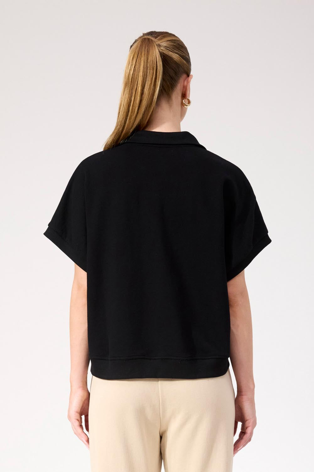 A model wearing the Boston Crop Sweat Top in colour Black (Black), from the back