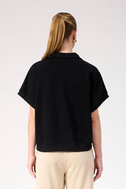 A model wearing the Boston Crop Sweat Top in colour Black (Black), from the back