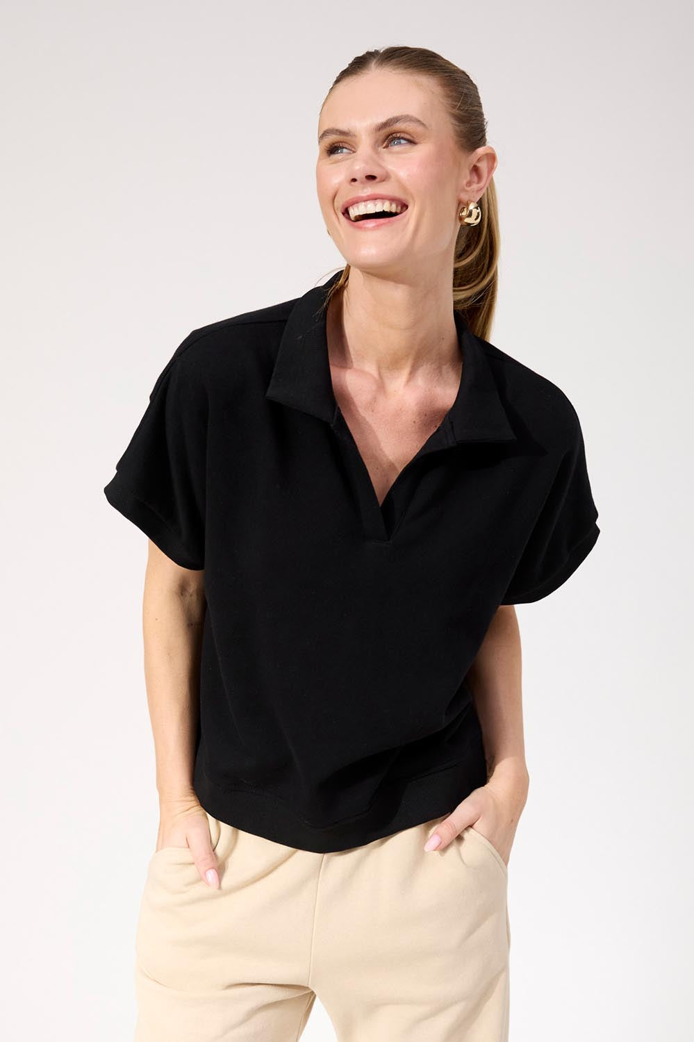 A model wearing the Boston Crop Sweat Top in colour Black (Black), from the front, cropped image