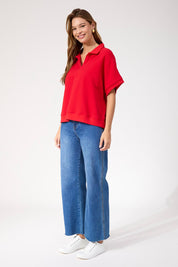 A model wearing the Boston Crop Sweat Top in colour Red (Red), from the front, showing the whole outfit