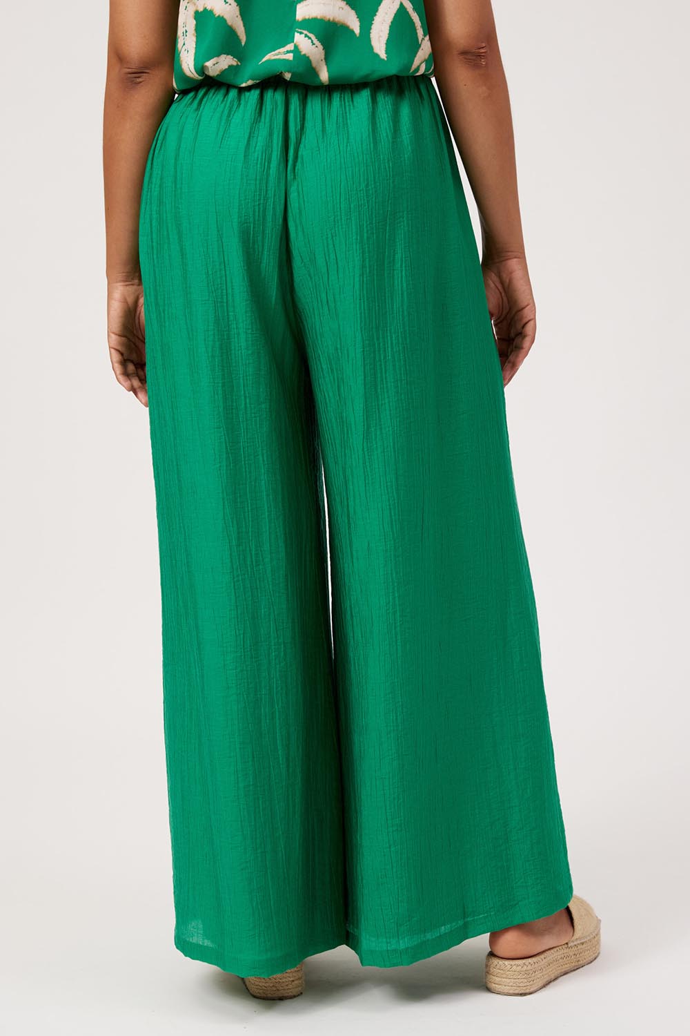 Model Genericm wearing size sample of the Kenya Palazzo Pant – Green in colour Green, from the front