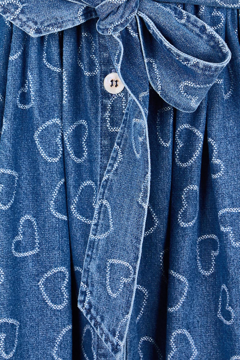 Product shot of the Sicily Heart Denim Shirt Dress – Indigo in colour Indigo, showing detail