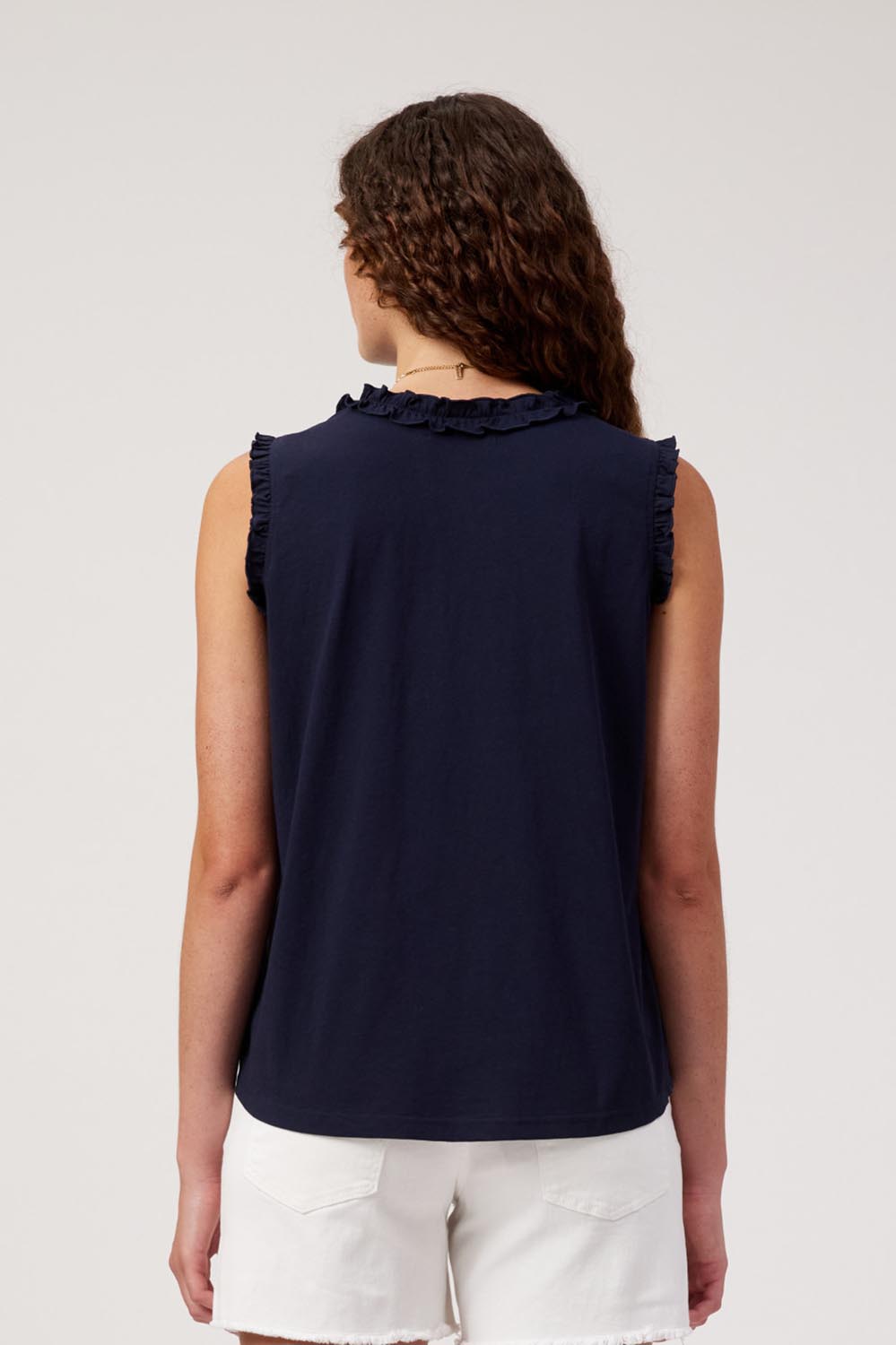 Model Genericm wearing size sample of the Athens Frill Tank – Navy in colour Navy, from the back