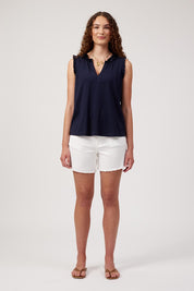 Model Genericm wearing size sample of the Athens Frill Tank – Navy in colour Navy, from the front