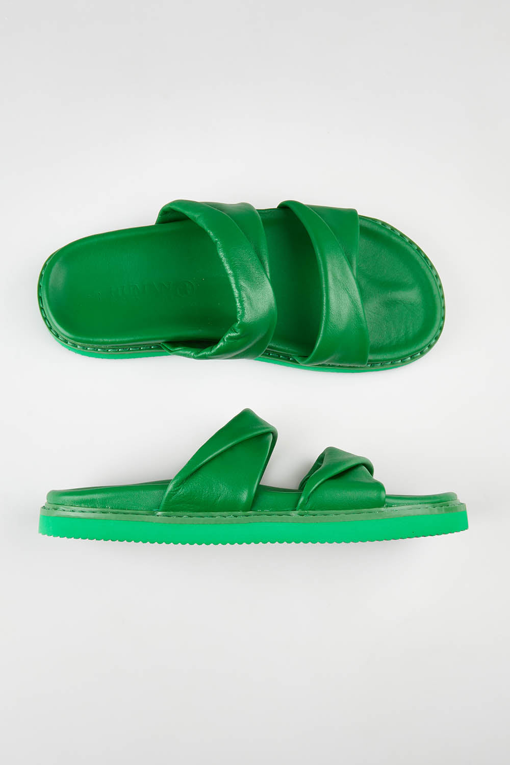 A model wearing size 37 of the Ahoy Leather Slide in colour Green (Green), from the front, showing the whole outfit