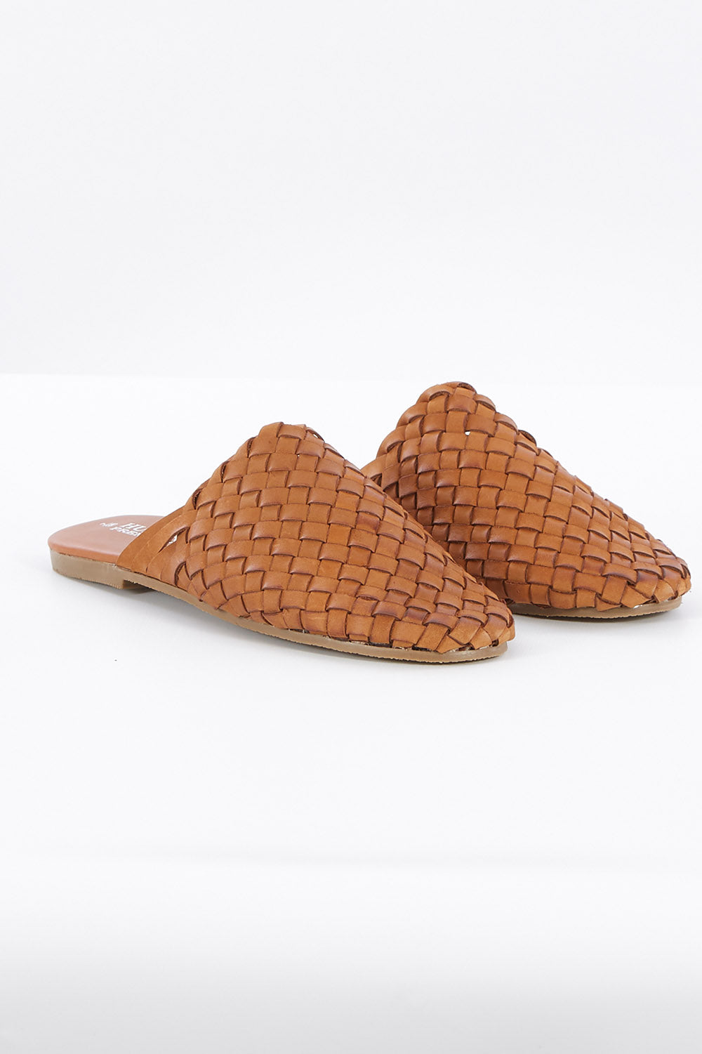 A model wearing size 37 of the Barland Woven Leather Mule in colour Tan, from the front, showing the whole outfit