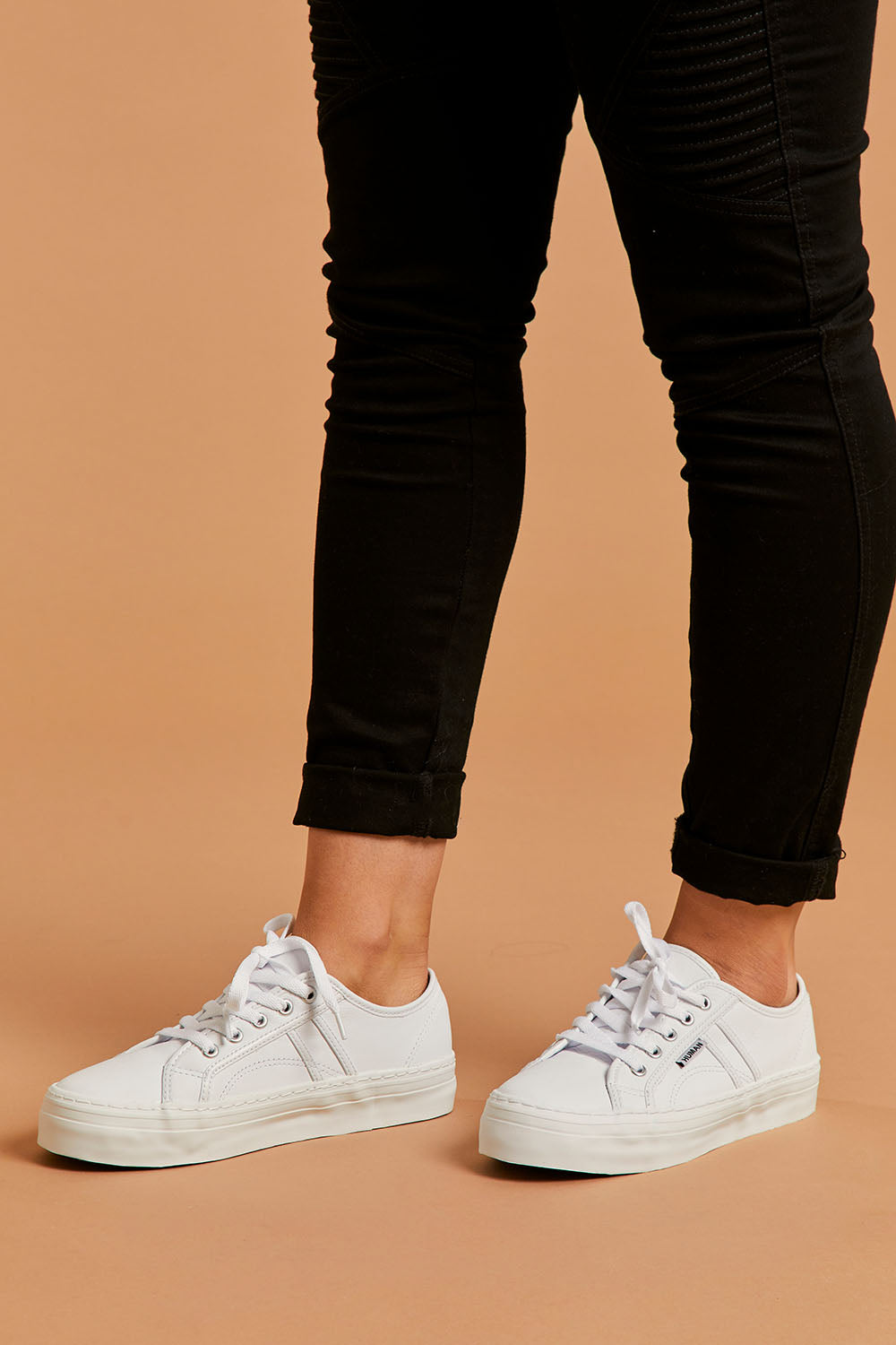 A model wearing size 39 of the Cass Sneaker in colour White (White), from the front, cropped image