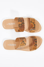 A model wearing size 38 of the Dakota Leather Sandal in colour Python, from the front, showing the whole outfit