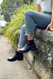 A model wearing the Jam Neoprene Waterproof Boot in colour Black (Black), from the front, showing the whole outfit
