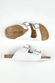 A model wearing size 37 of the Lynx Leather Slide Sandal in colour White (White), from the front, showing the whole outfit
