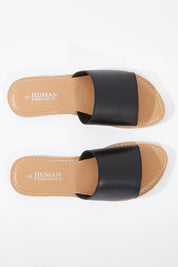 A model wearing size 38 of the River Leather Sandal in colour Black (Black), from the front, showing the whole outfit