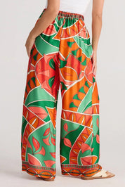 A model wearing the Playa Pant in colour Rainforest, from the back