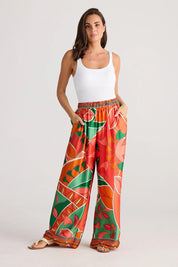 A model wearing the Playa Pant in colour Rainforest, from the front, showing the whole outfit