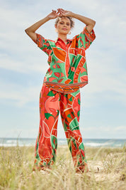 Model Lala wearing size S of the Playa Pant in colour Rainforest, from the front, showing the whole outfit