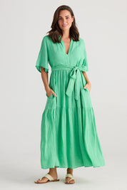 A model wearing the Lynwood Linen Dress in colour Apple (Green), from the front, showing the whole outfit