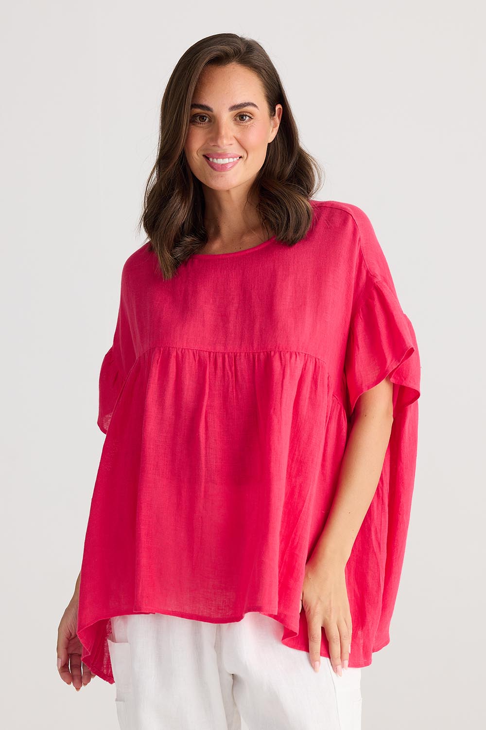 A model wearing the Caicos Linen Top in colour Raspberry (Blue), from the front, cropped image