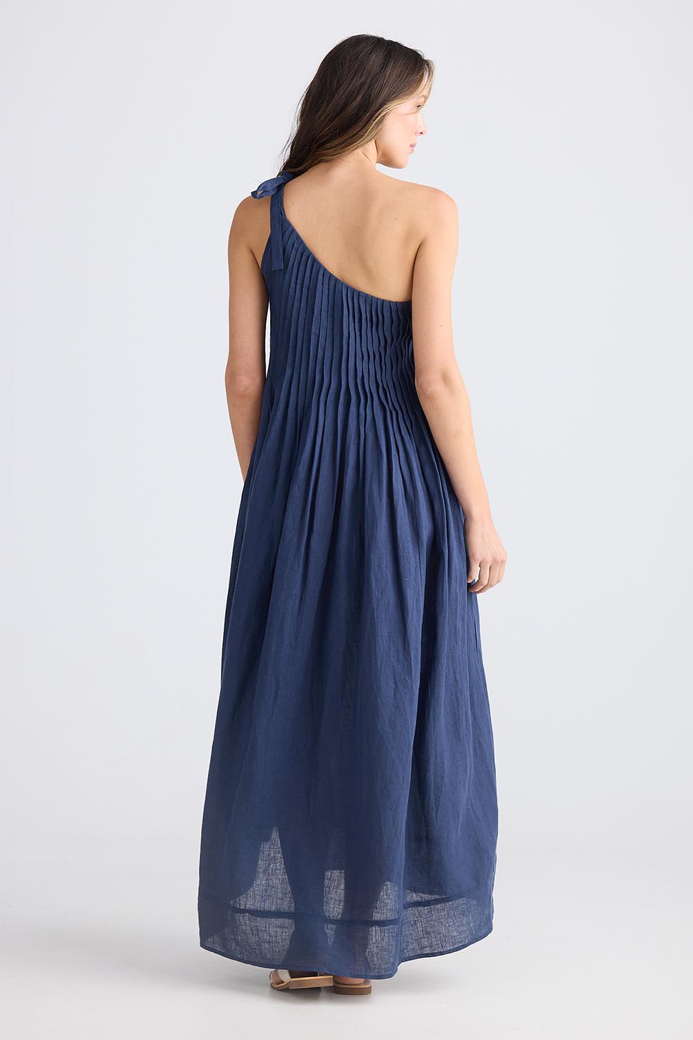 A model wearing the Lana Linen Maxi Dress in colour Navy (Blue), from the back