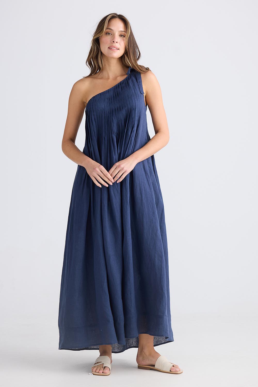 A model wearing the Lana Linen Maxi Dress in colour Navy (Blue), from the front, showing the whole outfit