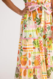 A model wearing the Avery Cotton Maxi Dress in colour Tropical, from the front, cropped image