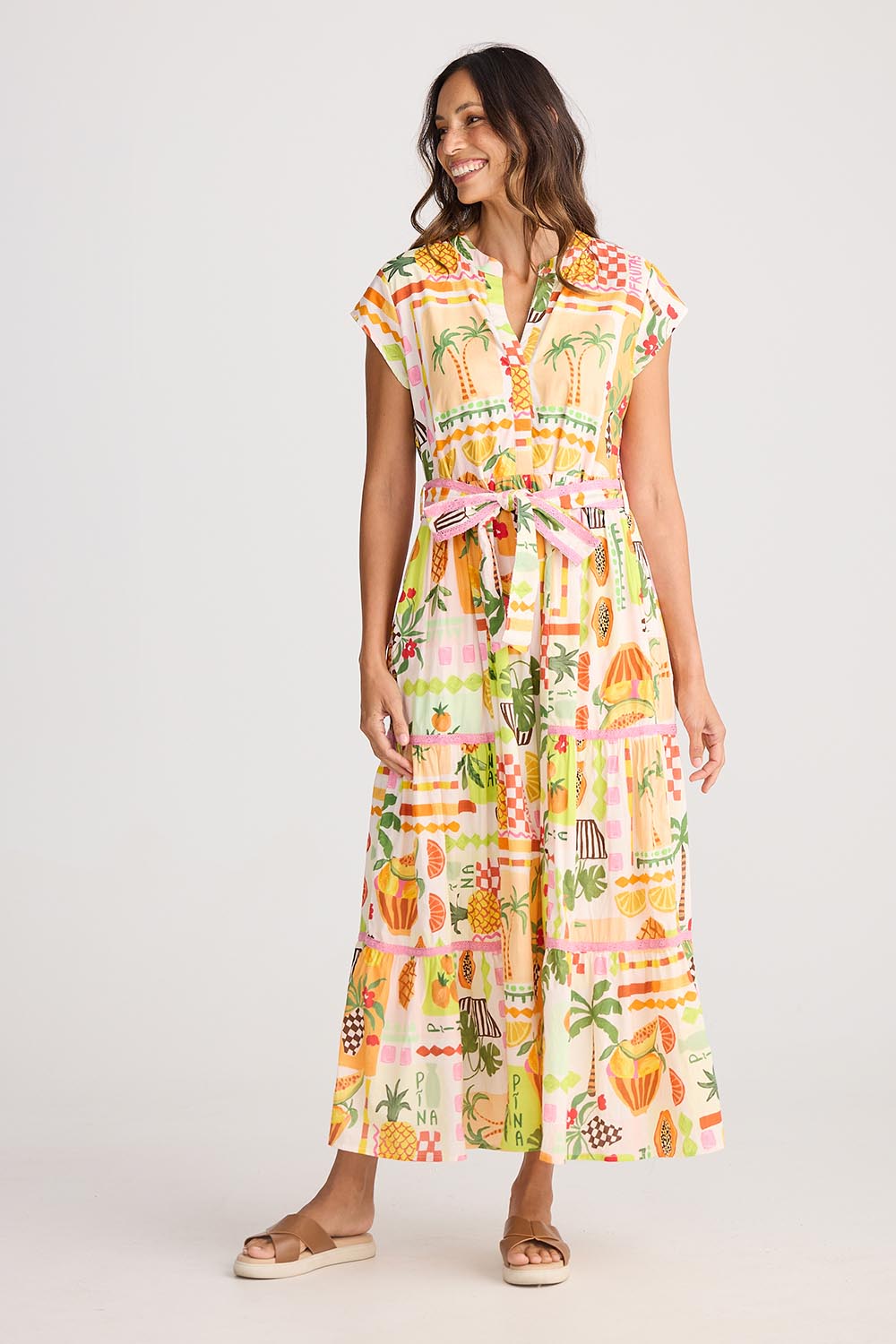 A model wearing the Avery Cotton Maxi Dress in colour Tropical, from the front, showing the whole outfit