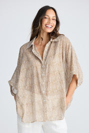 A model wearing the Indigo Cotton Shirt in colour Taupe, from the front, cropped image