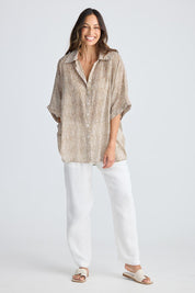 A model wearing the Indigo Cotton Shirt in colour Taupe, from the front, showing the whole outfit