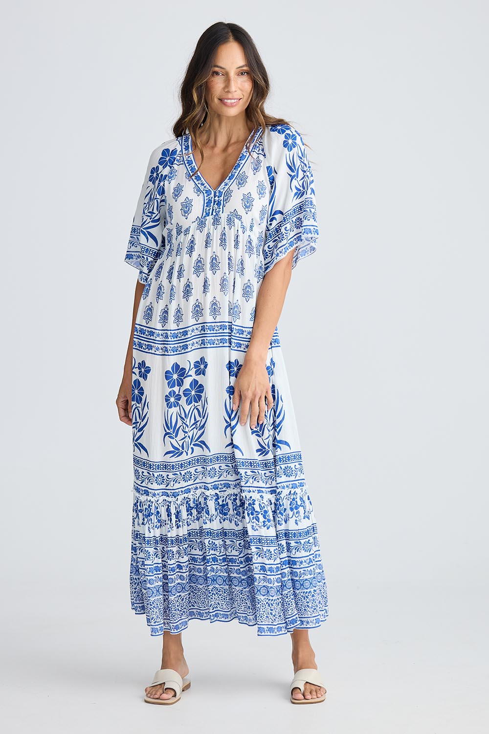 A model wearing the Swell Maxi Dress in colour Oceanpara (Blue), from the front, showing the whole outfit