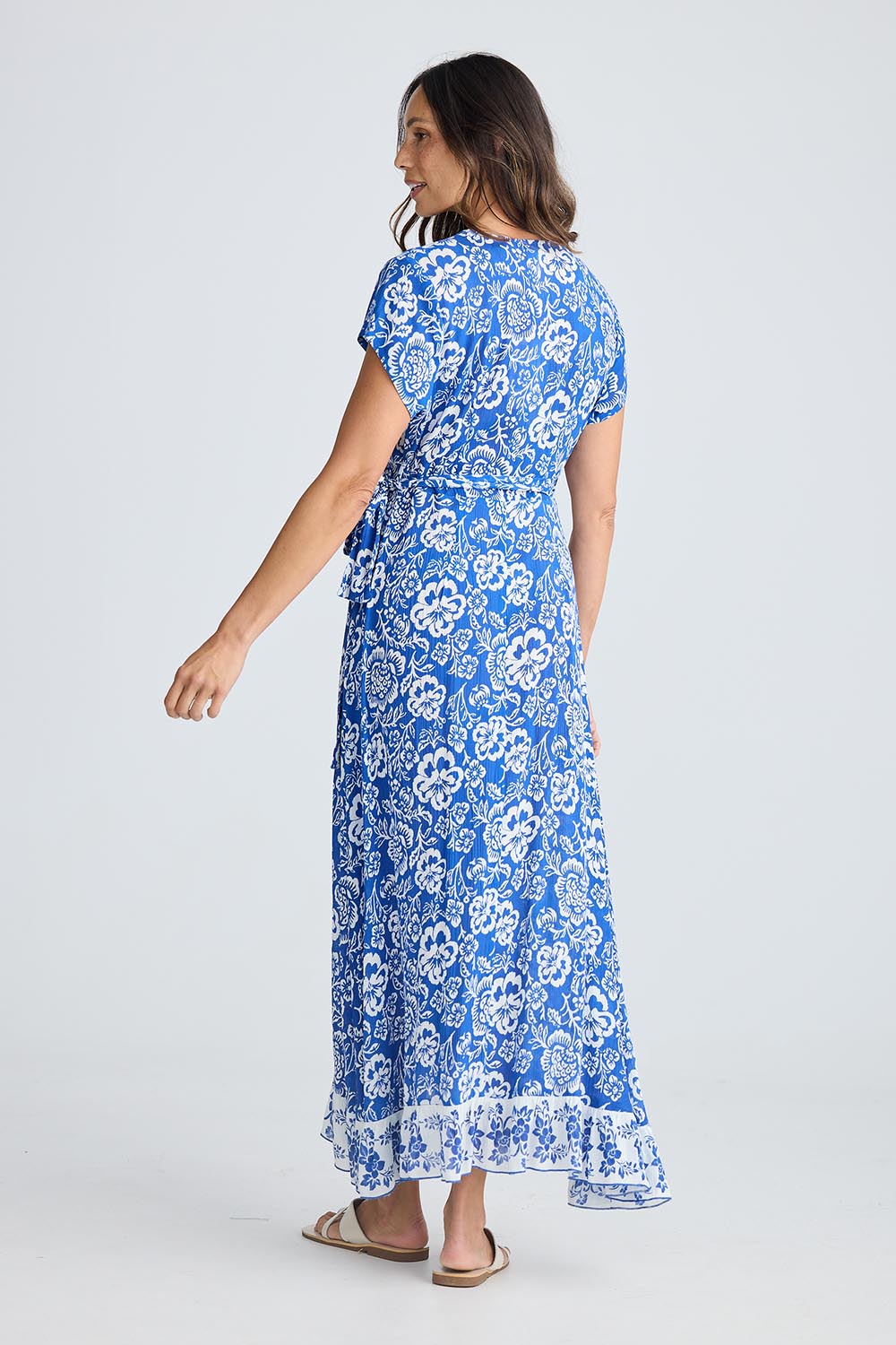 A model wearing the Lotus Wrap Dress in colour Oceanpara (Blue), from the back