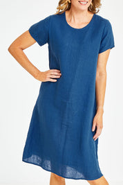 Model Naomi wearing size S of the Sabi Dress in colour Ocean (Blue), from the front, cropped image