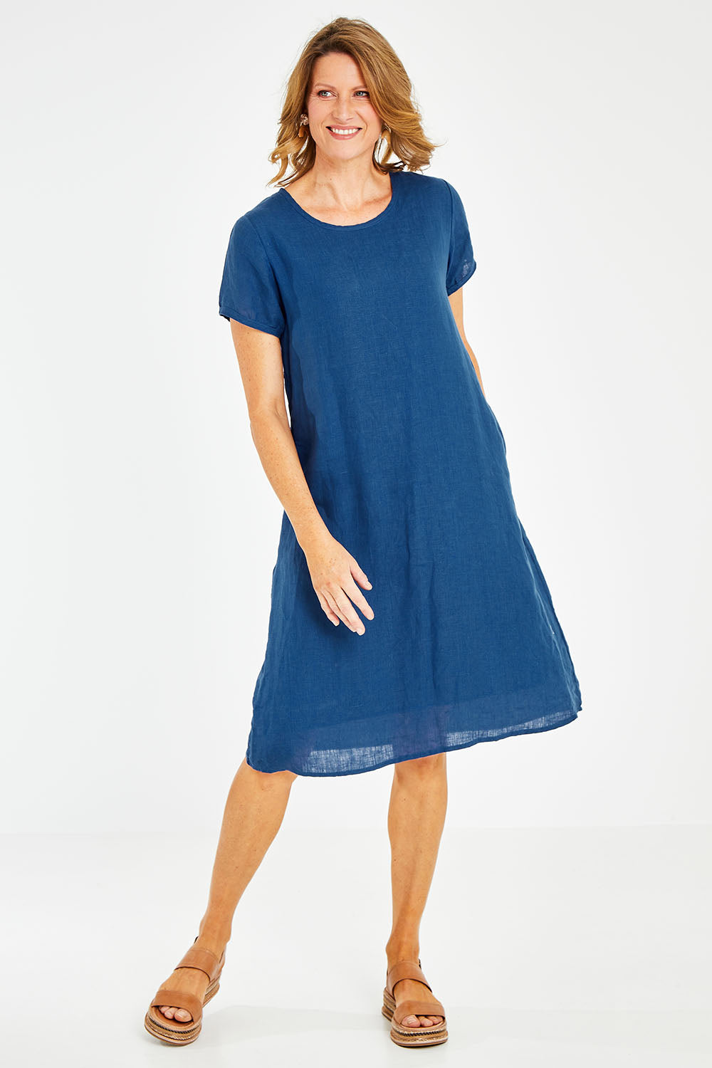 Model Naomi wearing size S of the Sabi Dress in colour Ocean (Blue), from the front, showing the whole outfit