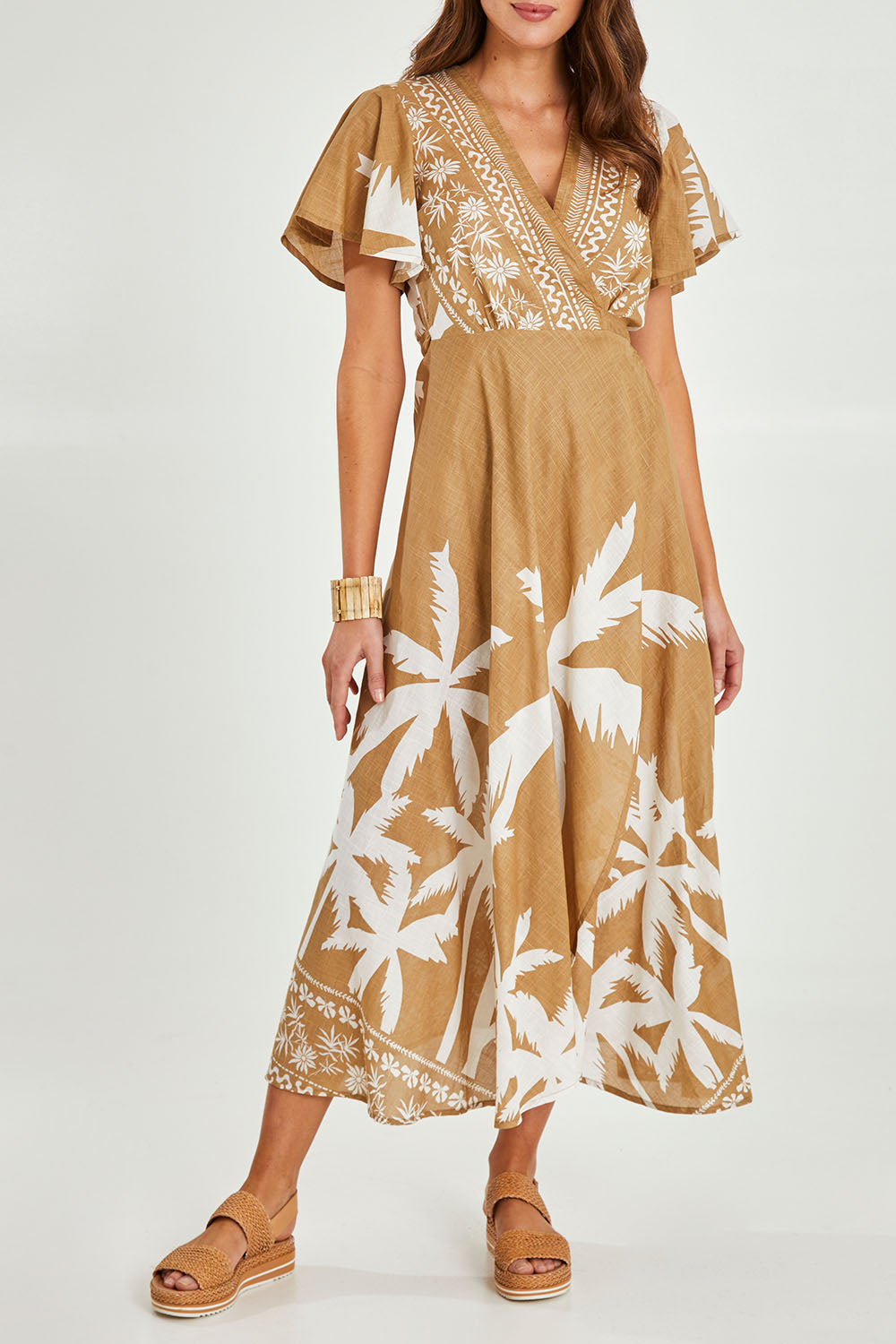 Model Madeline wearing size S of the Tropics Wrap Dress in colour Haven, from the front, cropped image