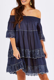 Model Chesska wearing size S-M of the Penzance Dress in colour Indigo (Blue), from the front, cropped image