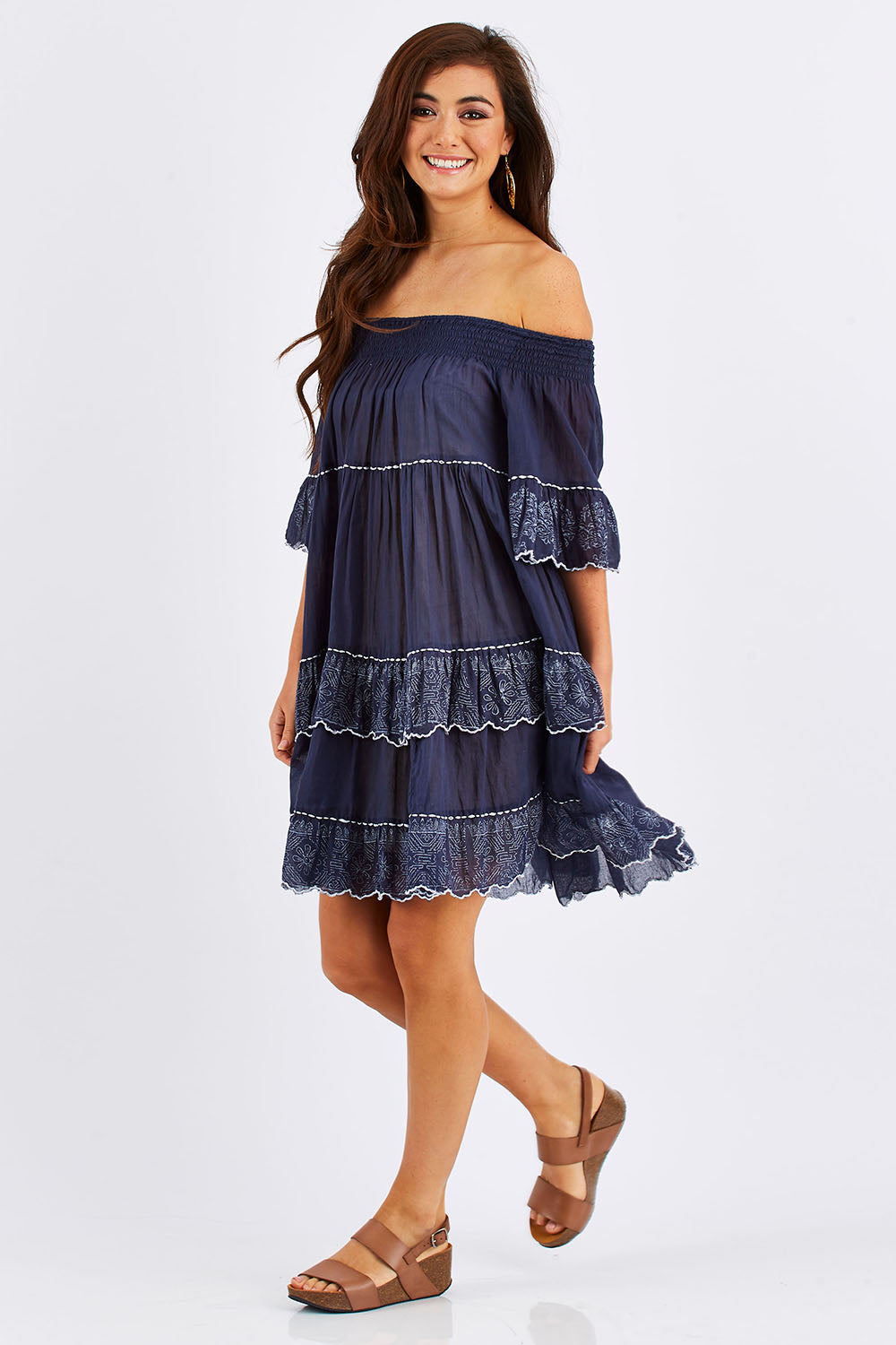 Model Chesska wearing size S-M of the Penzance Dress in colour Indigo (Blue), from the front, showing the whole outfit