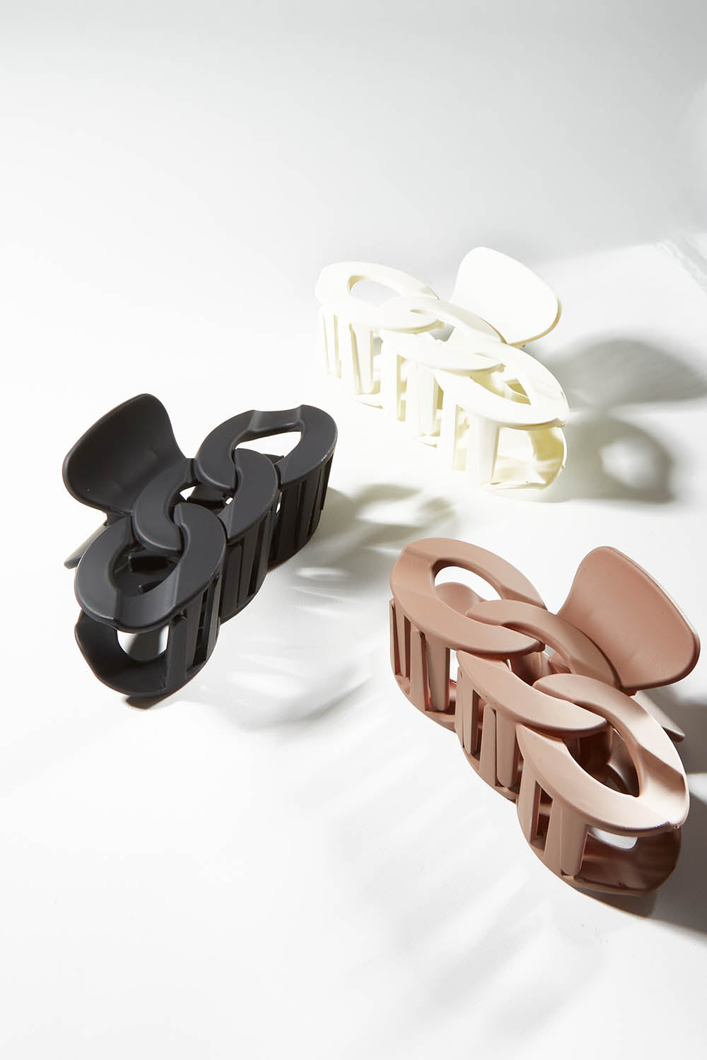 A model wearing size OneSize of the Link Hair Claw Clip in colour Taupe, from the front, showing the whole outfit