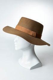 A model wearing size OneSize of the Ballina Hat in colour Olive (Green), from the front, showing the whole outfit