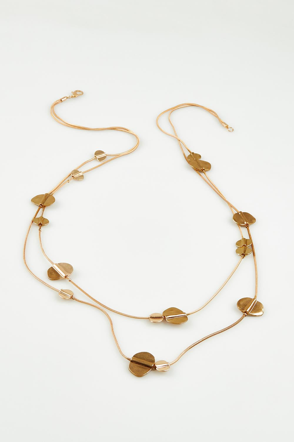A model wearing the Toronto Necklace in colour Gold (Metallics), from the front, showing the whole outfit