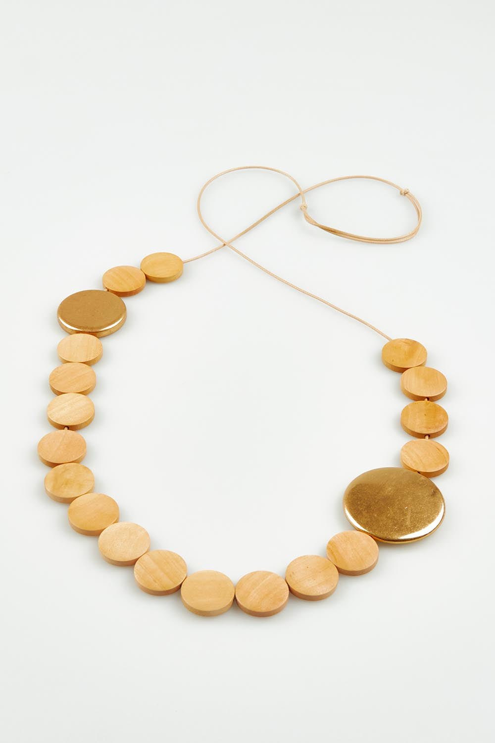 A model wearing the Lima Necklace in colour Natural, from the front, showing the whole outfit