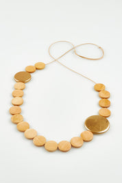 A model wearing the Lima Necklace in colour Natural, from the front, showing the whole outfit