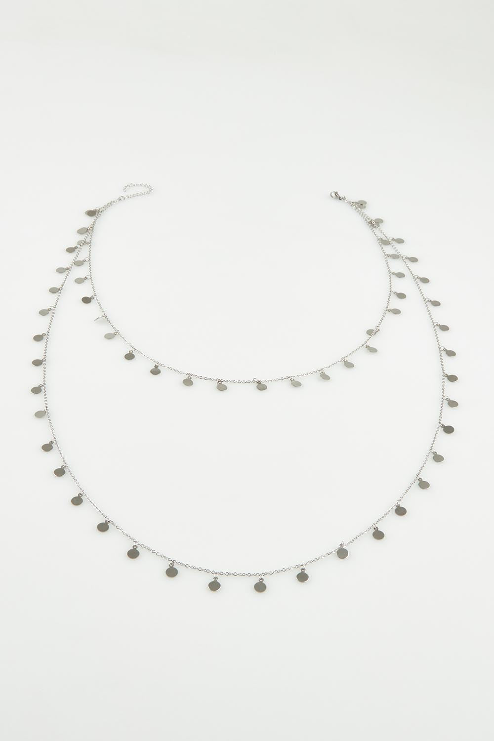 A model wearing the Cosmos Necklace in colour Silver (Metallics), from the front, showing the whole outfit