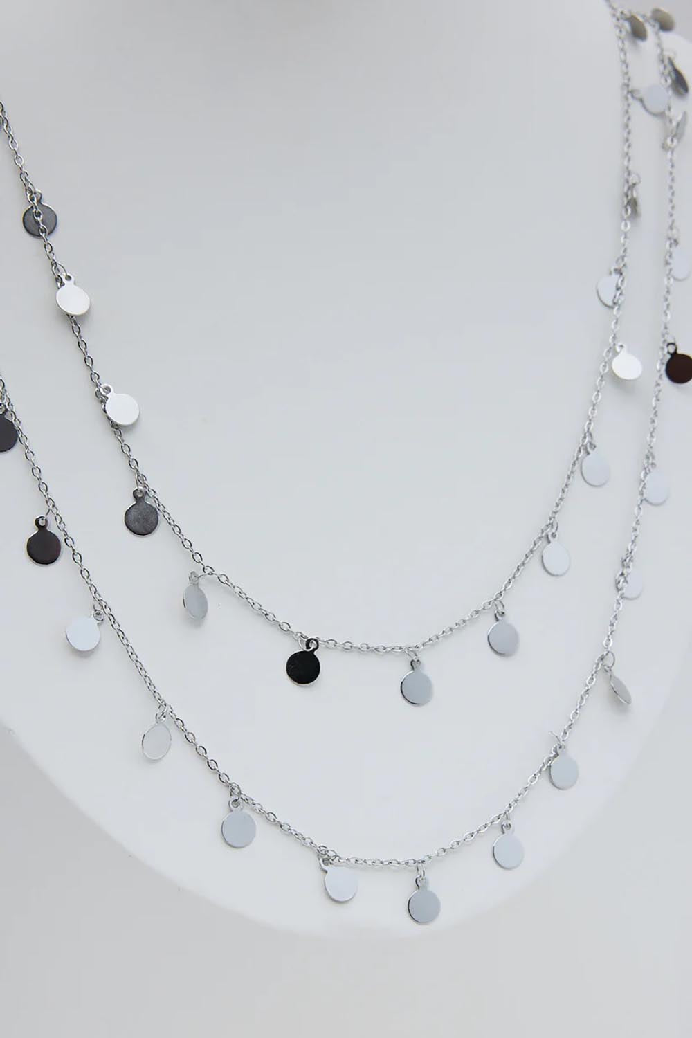 A model wearing the Cosmos Necklace in colour Silver (Metallics), from the front, showing the whole outfit