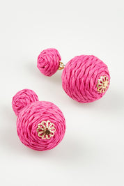 A model wearing the Ophilia Earrings in colour Hotpink (Pink), from the front, showing the whole outfit