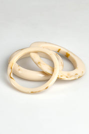 A model wearing the Highways Bangle in colour Set Of 3 - Natural, from the front, showing the whole outfit
