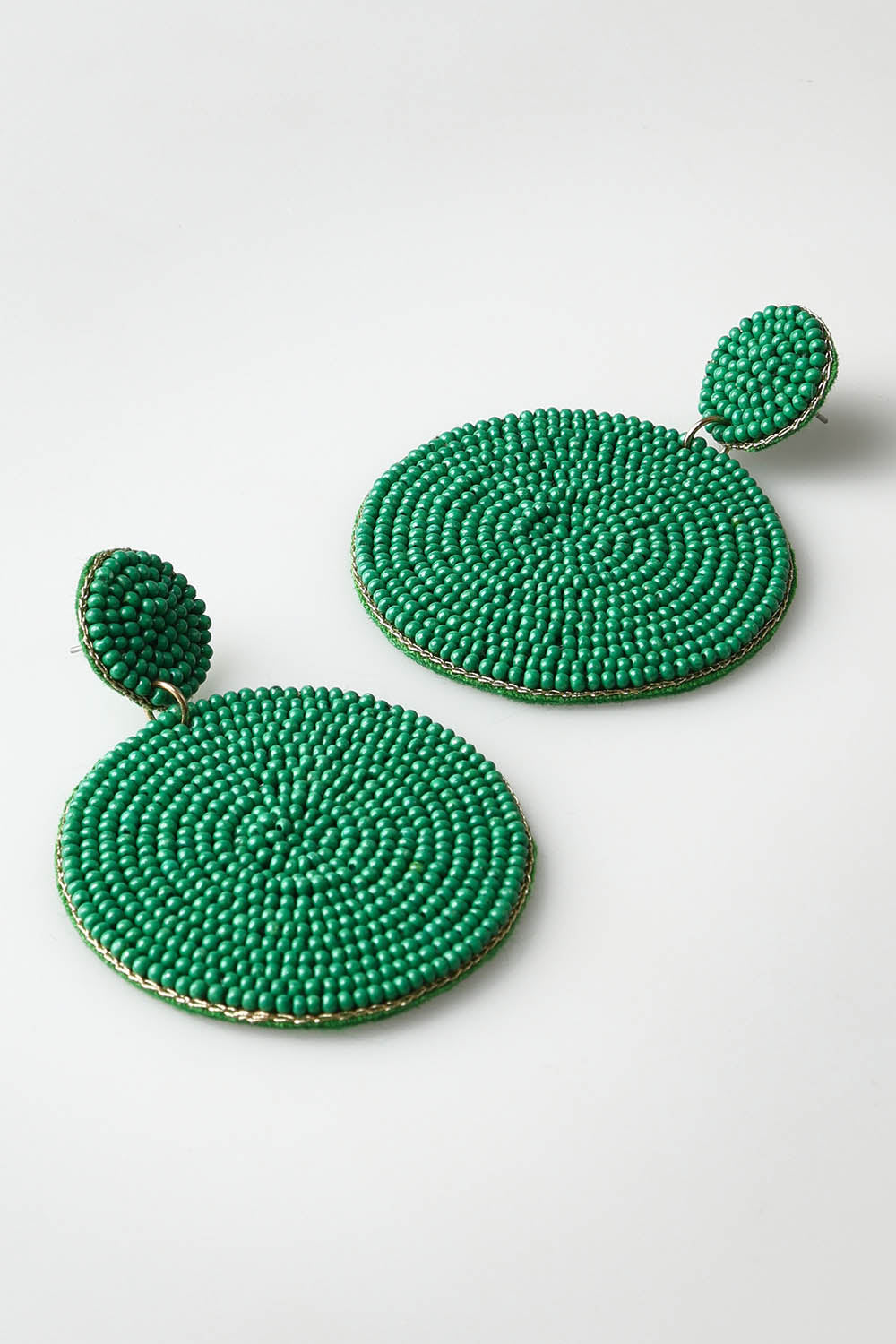 A model wearing the Sun Beam Earring in colour Green (Green), from the front, showing the whole outfit