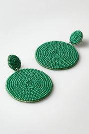 A model wearing the Sun Beam Earring in colour Green (Green), from the front, showing the whole outfit